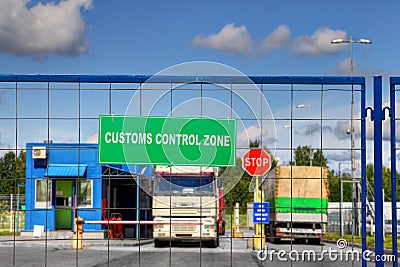 Trucks pass through checkpoint of customs logistics terminal. Stock Photo
