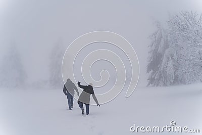 Trudge through deep snow in foggy winter landscape Stock Photo
