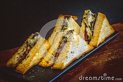 Truffle Tramezzini Melted mozzarella on tender beef bacon in brioche bread with black truffle pate Stock Photo