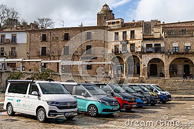 Many colorful camper vans parked in the Plaza Mayor square in the historic city center of Trujillo Editorial Stock Photo