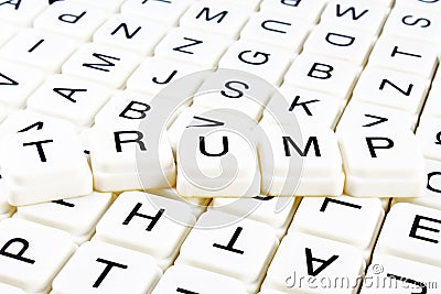 Trump title text word crossword. Alphabet letter blocks game texture background. White alphabetical letters on black Editorial Stock Photo