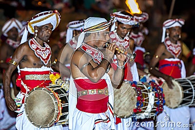 A Trumpet Blower performs ahead of a group of Davul Players during the Esala Perahera in Kandy in Sri Lanka. Editorial Stock Photo