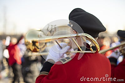 Trumpeter plays in orchestra. Musician with wind musical instrument. Red clothes Editorial Stock Photo