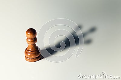 Trust yourself concept - chess pawn with king shadow Stock Photo