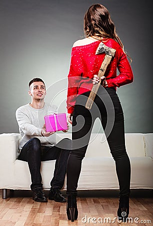Trusting guy giving present to misleading girl Stock Photo