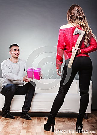 Trusting guy giving present to misleading girl Stock Photo