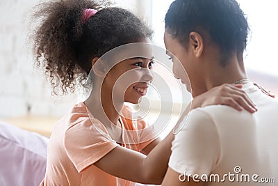 Affectionate loving black mother and daughter enjoying happy moments together Stock Photo