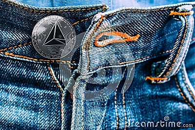 Trx coin instead of buttons on jeans. Editorial Stock Photo