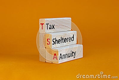 TSA, tax sheltered annuary symbol. Concept words TSA, tax sheltered annuary on wooden blocks. Beautiful orange table, orange Stock Photo