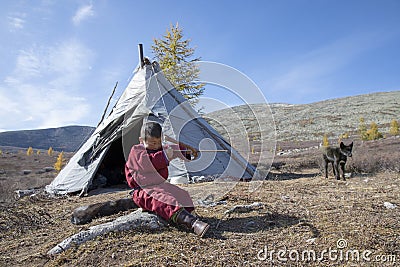 Tsaatan kid in a taiga of northern Mongolia Stock Photo