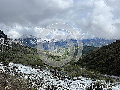 Tseylomsky pass in Ingushetia. A trip uphill to the Tsei Loam pass on a cloudy spring day. Panorama of the high cliffs Stock Photo