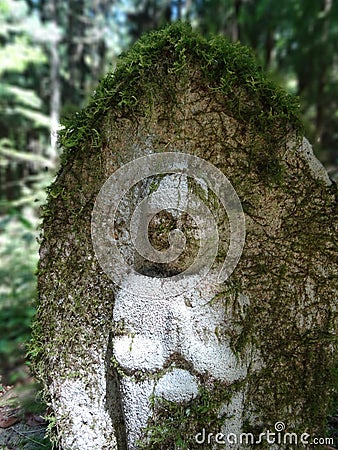 Small stone Jizo statue surrounded by green on the Nakasendo Road hike Editorial Stock Photo