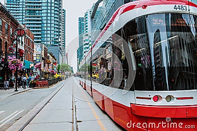 TTC Close view os a streetcar in downtown Toronto's entertainment district. New tram on streets of Toronto. TORONTO, ONTARIO Editorial Stock Photo