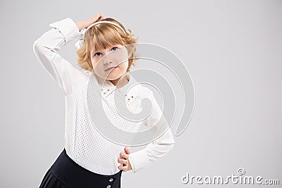 Tthe sweet schoolgirl girl thought about it and put her hand to her head. Stock Photo