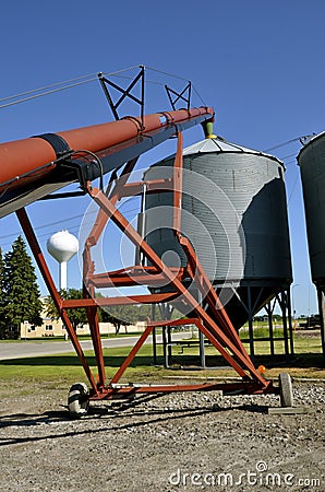 Tube elevator and grain bins in a small town Stock Photo