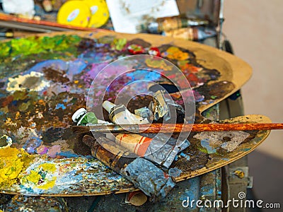 Tubes of paint on a palette for mixing oil paints Stock Photo