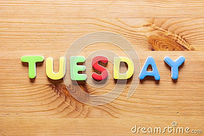 Tuesday word written with colorful letters on wooden table background Stock Photo