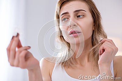 Tuft of hair in female hands Stock Photo