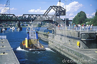 Tug boat going through Hiram M. Chittenden Locks on Puget Sound, Seattle, WA Editorial Stock Photo