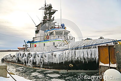 Tug frozen from freezing temps leaving for Editorial Stock Photo