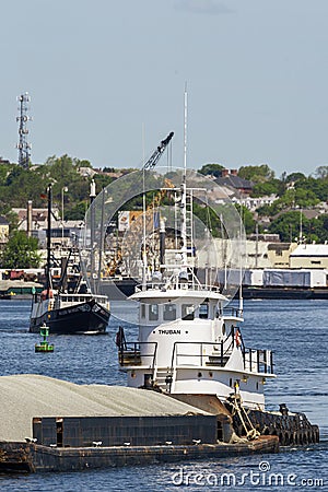 Tug Thuban pushing sand barge out of New Bedford harbor Editorial Stock Photo