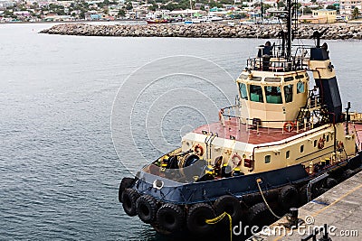 Tug with Tire Bumpers in St Kitts Stock Photo