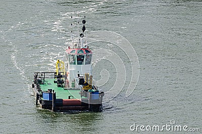 TUG IS MANEUVERING AT SEA Stock Photo