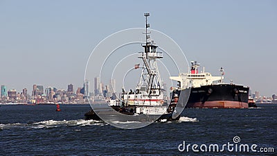 Tugboat ANDREA, moving eastward, and Crude Oil Tanker PHOENIX ADMIRAL, westward, at the entrance to Kill Van Kull strait Editorial Stock Photo