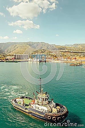 A tugboat is going in the port Editorial Stock Photo