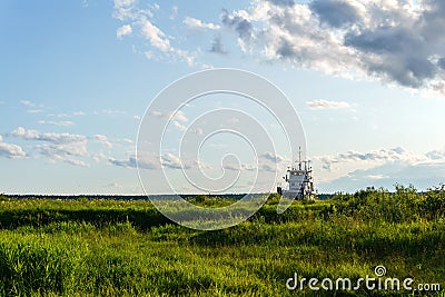 Tugboat in the grass sea Stock Photo