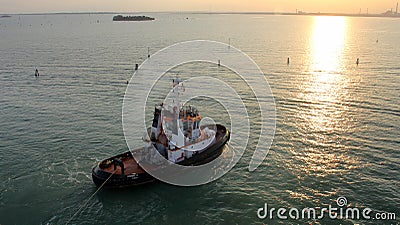 Tugboat IVONNE C in Venice Lagoon at sunset Editorial Stock Photo