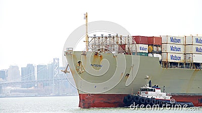 Tugboat PATRIOT assisting Cargo Ship MATSONIA to maneuver Editorial Stock Photo