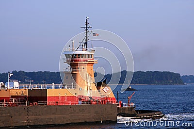 Tugboat pushing barge Stock Photo