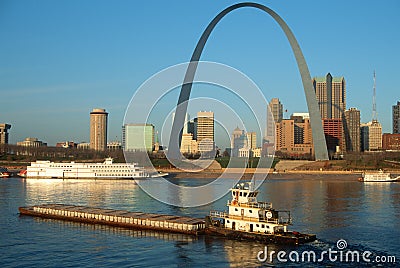 Tugboat pushing barge in front of Archway in St. Louis, Missouri Editorial Stock Photo