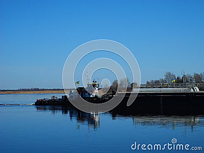 the tugboat sails along the Dnieper River Editorial Stock Photo