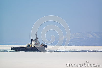 The tugboat sails among the ice Editorial Stock Photo
