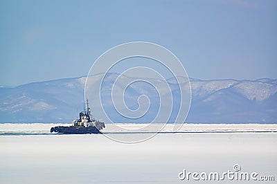 The tugboat sails among the ice Editorial Stock Photo