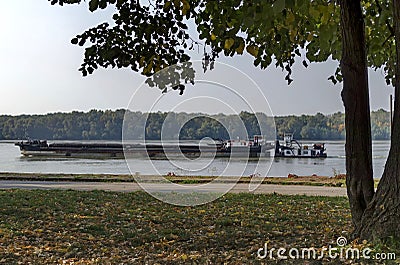 Tugboat with ship pass along the riverside park in Ruse town Editorial Stock Photo