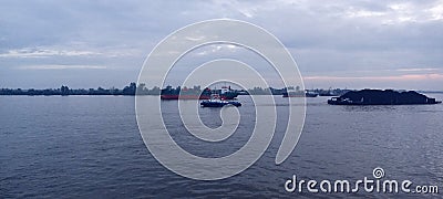 Tugboat towing the barge Stock Photo