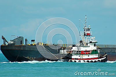 Tugboat towing barge Stock Photo