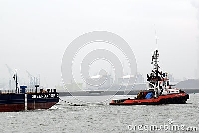 Tugboat is towing cargo platform towards the North Sea Editorial Stock Photo