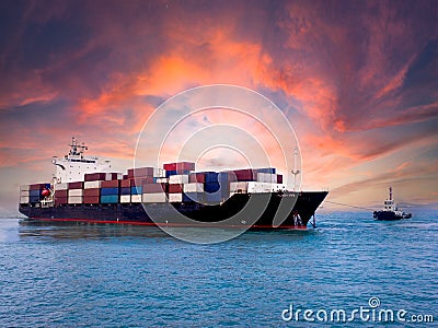 A tugboat towing a container vessel Stock Photo