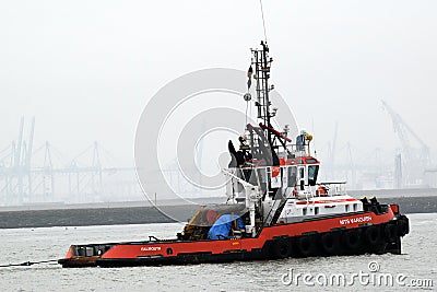 Tugboat towing a large installation to open sea Editorial Stock Photo
