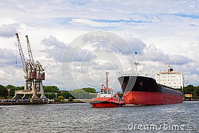 Tugboat towing a ship Stock Photo