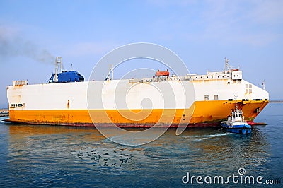 Tugboat towing a ship Stock Photo