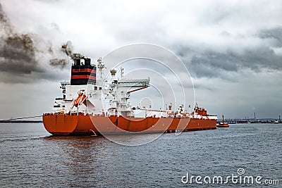 Tugboat towing a ship Stock Photo