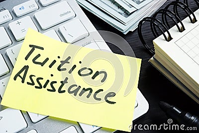 Tuition assistance handwritten on a piece of paper Stock Photo