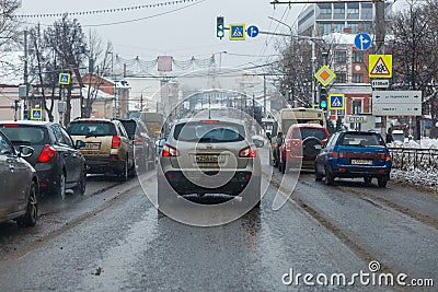 Tula, Russia - February 21, 2021: Cars stopped on crossroads traffic lights at winter day on main street. Editorial Stock Photo