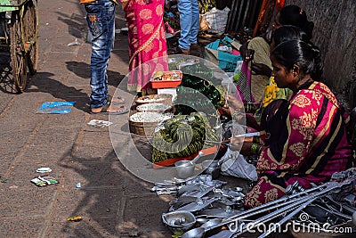 Street vendor selling aluminum utensils in Indian street market Editorial Stock Photo