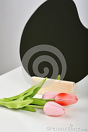 Tulip flowers bouquet for celebration with mirror. Artificial tulips on white table, Gift for special day Stock Photo